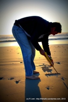 Richard starts to write my name in the sand