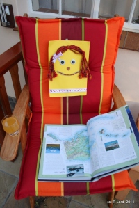 Flat Kathy reading up on her next exotic destination - the Wilds of Alaska!
